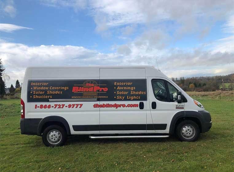 Company vehicle parked in a grassy field